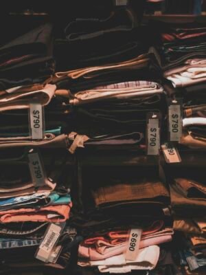 Neatly folded clothes with price tags on shelves in a Taipei shop.